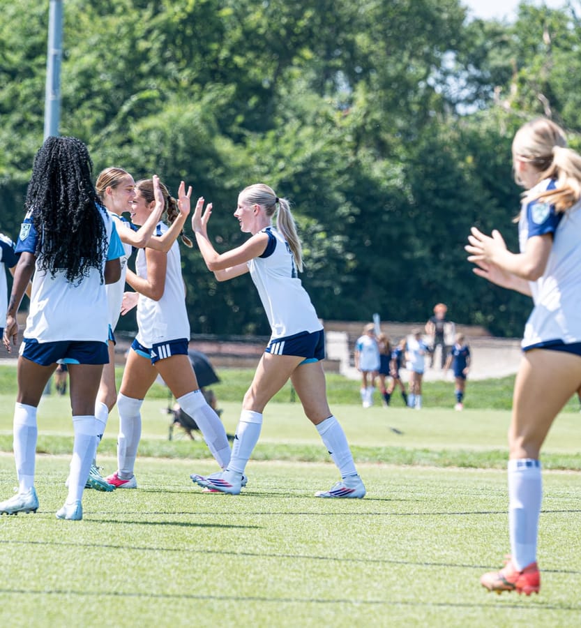 SBV ECNL Girls players celebrating together on the field