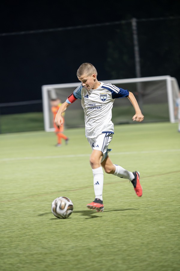 An SBV player dribbling during a night game