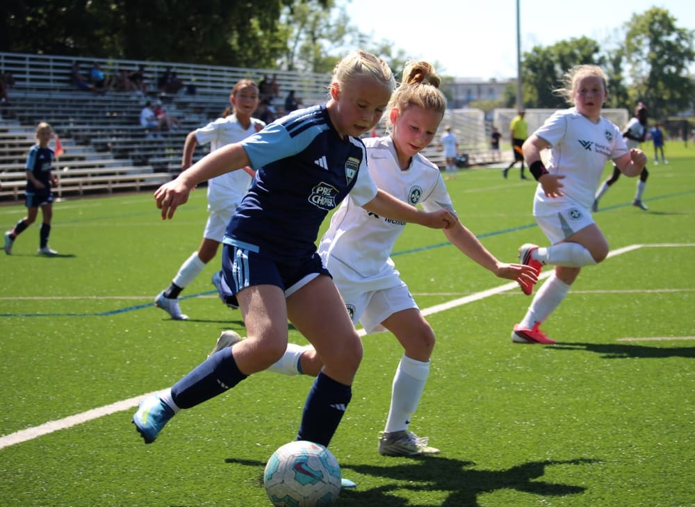 SBV U10 girls battling for the ball at a tournament